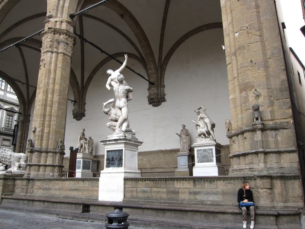 A young artist getting inspiration from the Loggia dei Lanzi outdoor sculpture gallery.